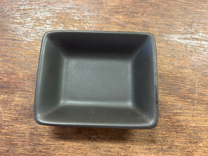 Black rectangle serving bowl with square corners and glossy finish.