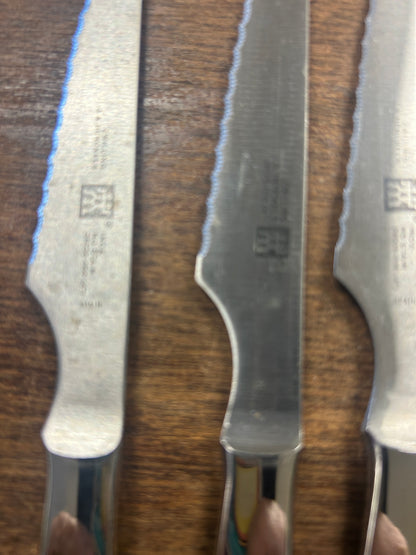 Stainless steak knife blades and handles with stamped logo detail