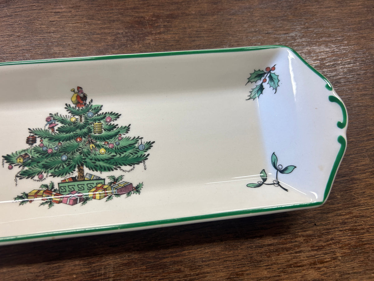 White porcelain Christmas tree platter with green border and painted tree scene, corner view