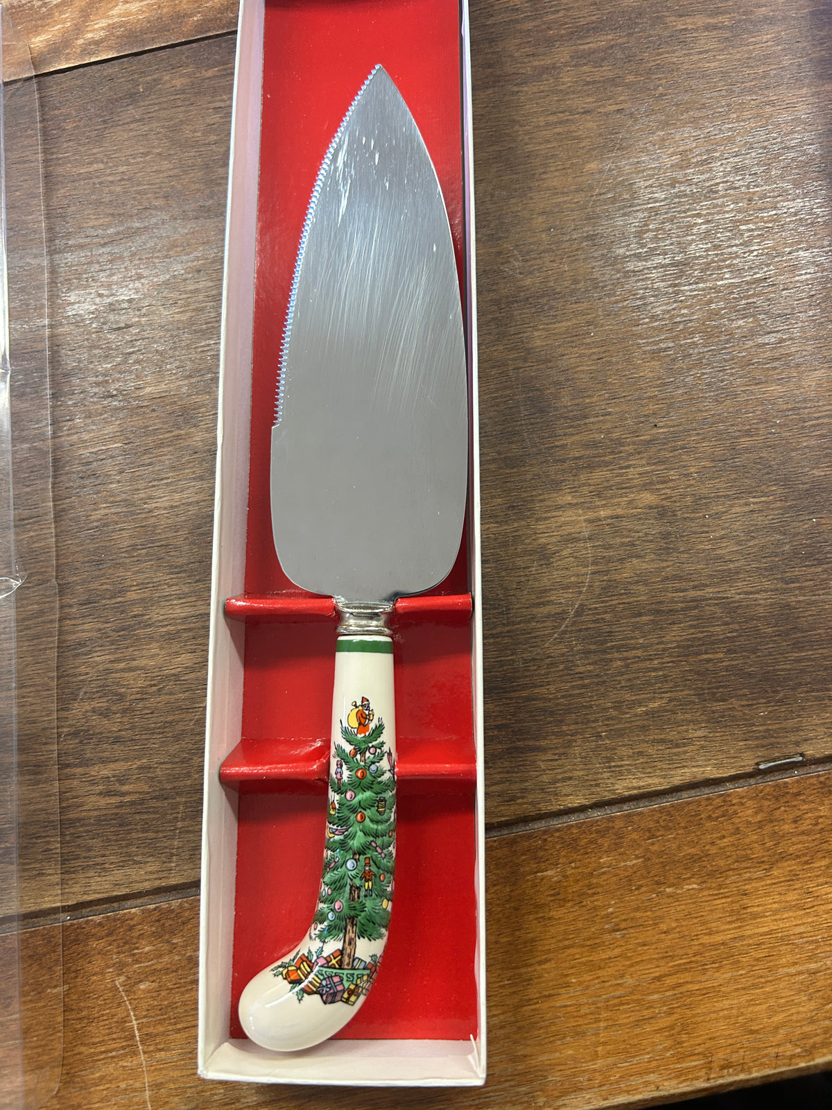 Christmas cake server with red handle and green tree motif, stainless steel blade