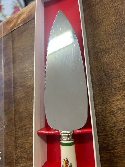 Christmas cake server with red handle, stainless steel blade, green tree motif