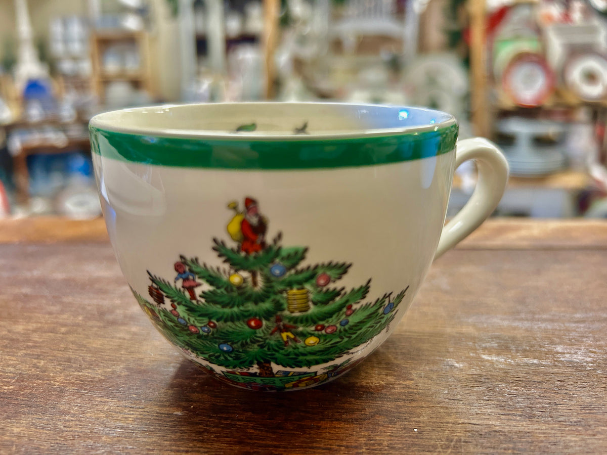 Ceramic Christmas cup with green rim and painted evergreen trees with red accents