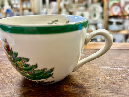 Ceramic Christmas cup with green rim and painted evergreen branches along the side