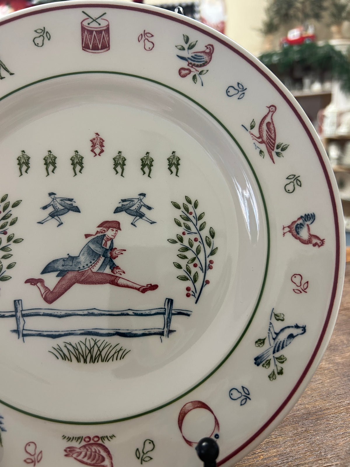 Multicolor Christmas plate close-up of horse rider scene and patterned decorative rim