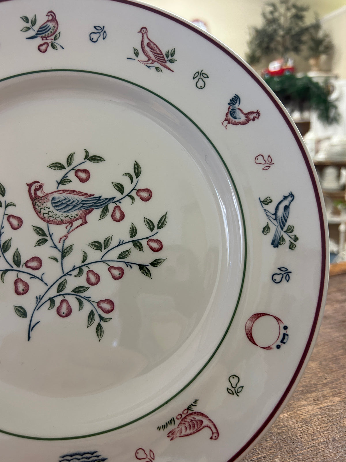 Johnson Bros Christmas plate with hanging bird and berry pattern around the edge