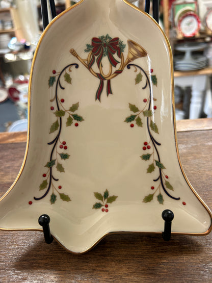 Cream bell-shaped serving bowl with gold trim and holiday holly and bow pattern