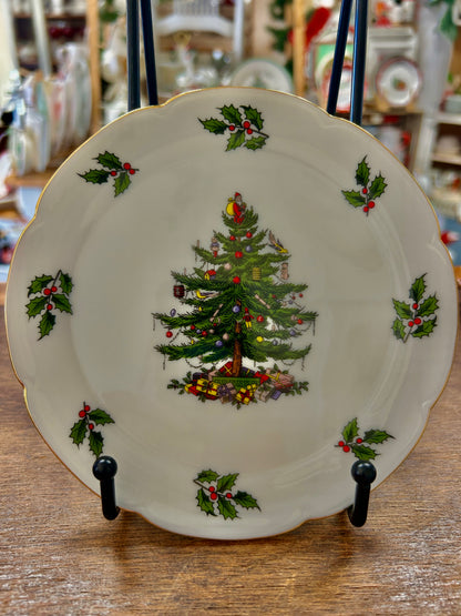 White Christmas plate with gold rim, illustrated tree, holly sprigs, and red accents.