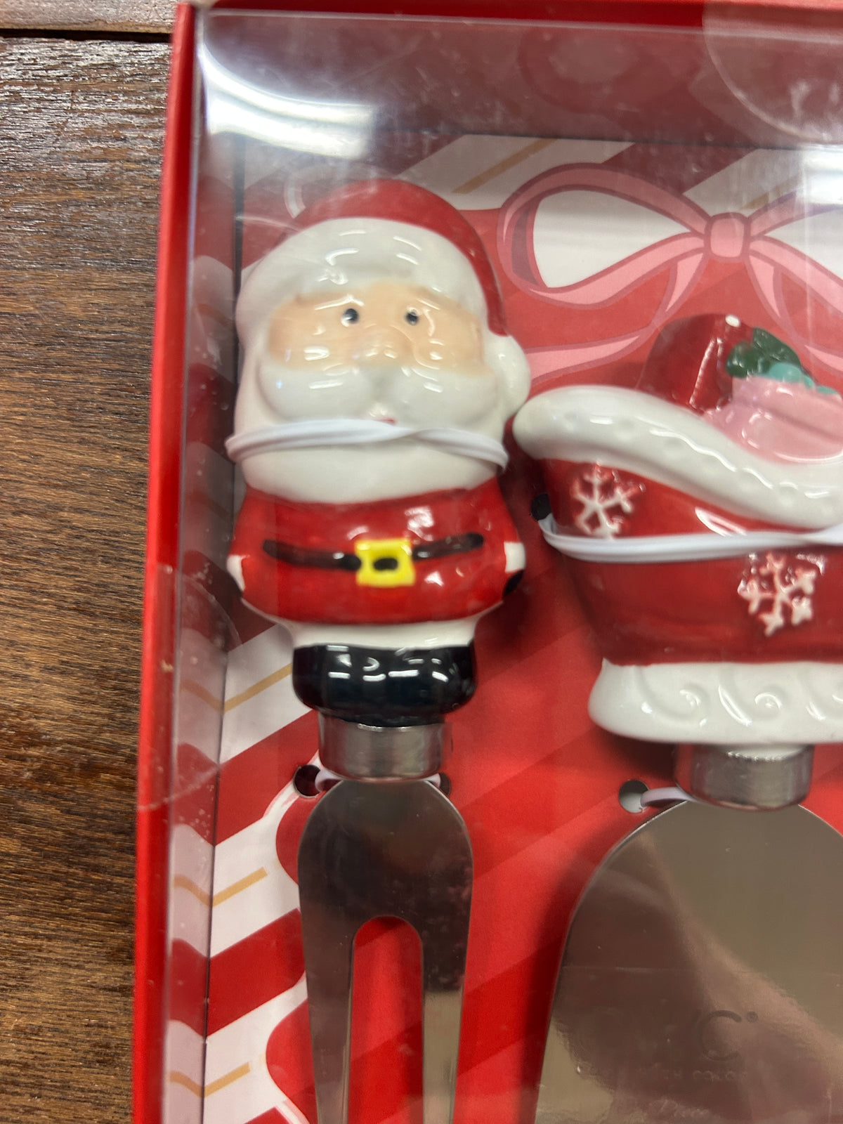 Santa-themed cheese knife in red box insert, figurine handle and metal blade