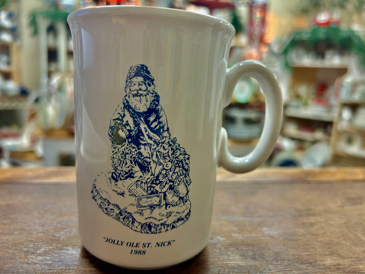 White mug with blue Jolly Ole St. Nick graphic and 'JOLLY OLE ST. NICK' 1988 text