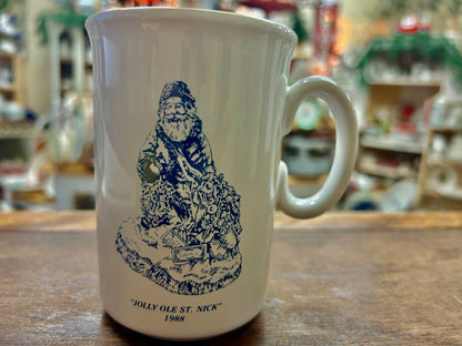 White mug with blue Jolly Ole St. Nick graphic and 'JOLLY OLE ST. NICK' 1988 text