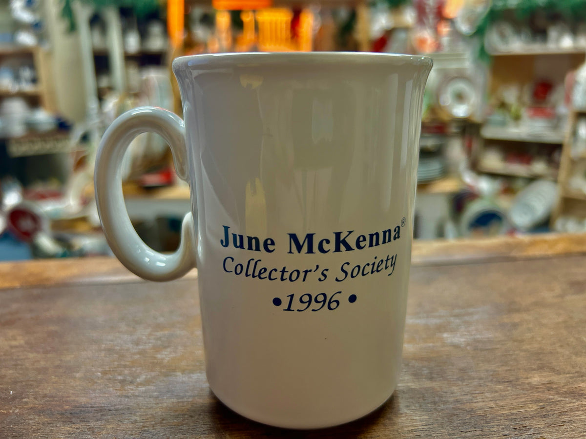 White mug with blue 'June McKenna Collector's Society' and 1996 text
