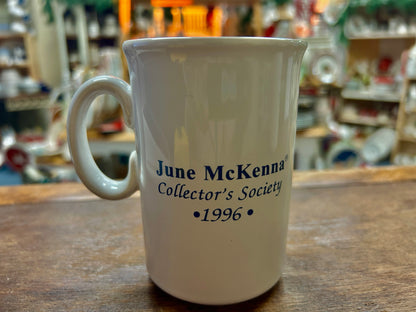 White mug with blue 'June McKenna Collector's Society' and 1996 text