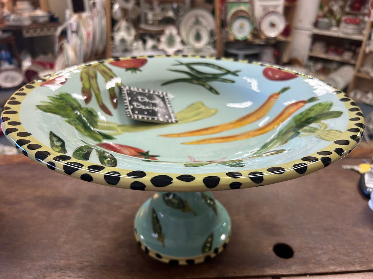 Multicolor vegetable pedestal bowl with illustrated greens, carrots, and dotted border
