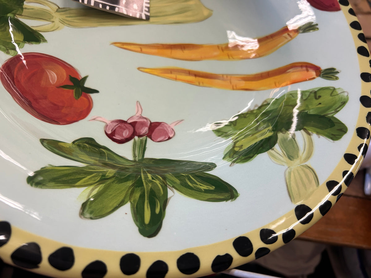 Vegetable bowl interior angled view with tomatoes, onions, herbs, and dotted border