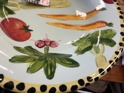 Vegetable bowl interior angled view with tomatoes, onions, herbs, and dotted border