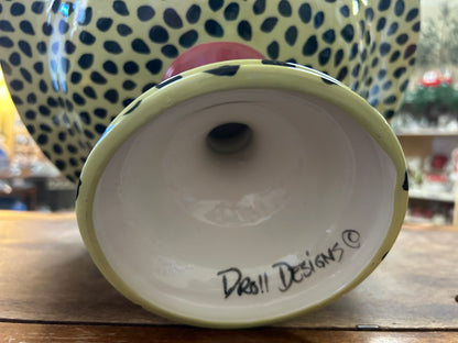 Underside of green ceramic pedestal bowl with "Droll Designs" stamp