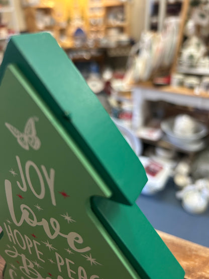 Green wooden Christmas tree side with 'Joy Love Hope Peace' lettering and butterfly