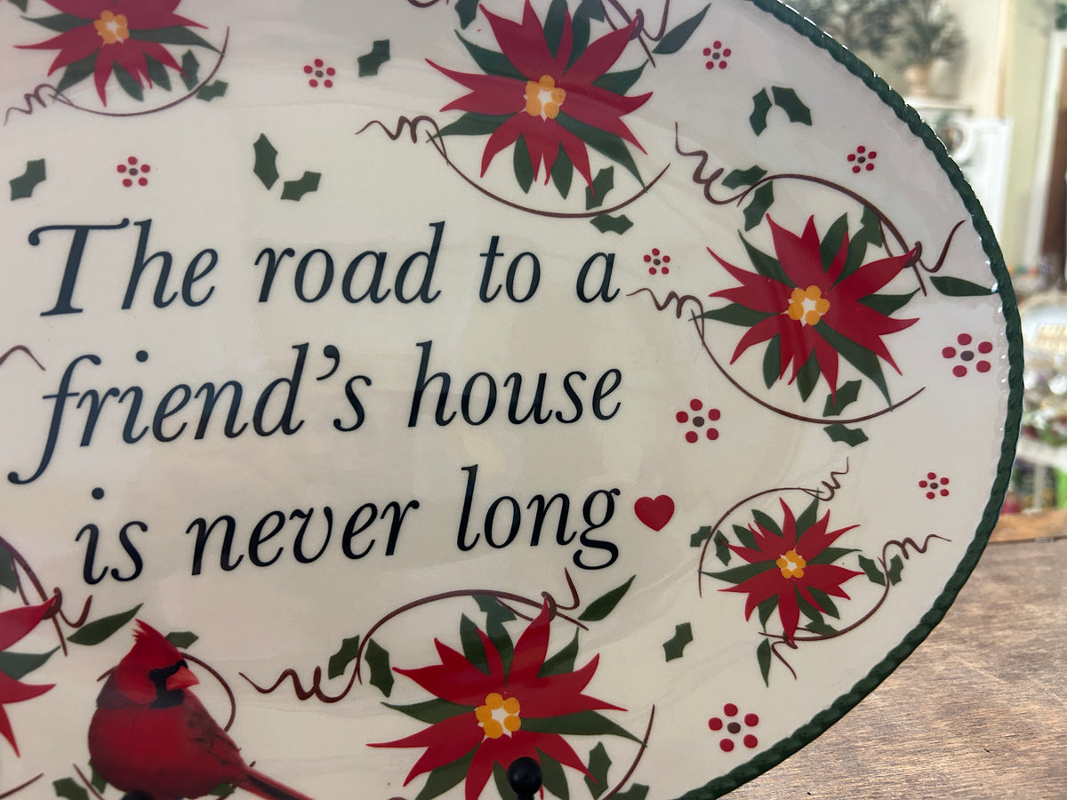 Oval platter corner detail with red cardinal, red flowers, and partial cursive quote