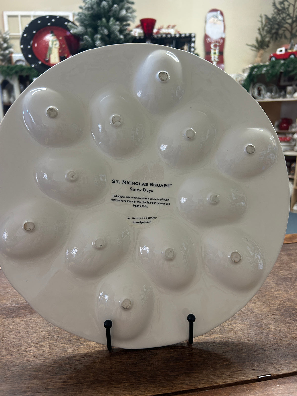 White ceramic deviled egg tray back with small text and raised egg-cup nubs