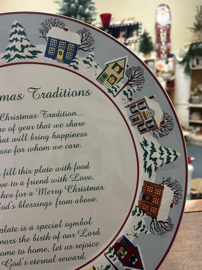 Round Christmas traditions platter angled view with multicolor houses and trees, red rim