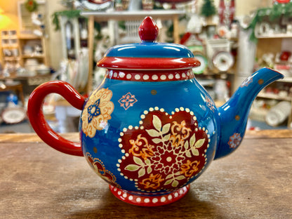 Blue and red patterned ceramic tea pot with domed lid and red handle