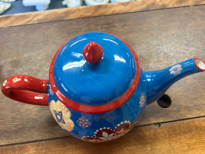 Blue ceramic tea pot top with red knob, lid rim, and red side handle