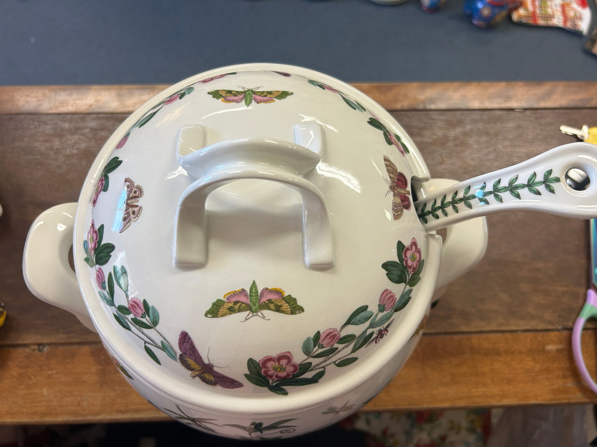Ceramic tureen lid with arched grip and botanical motifs on white