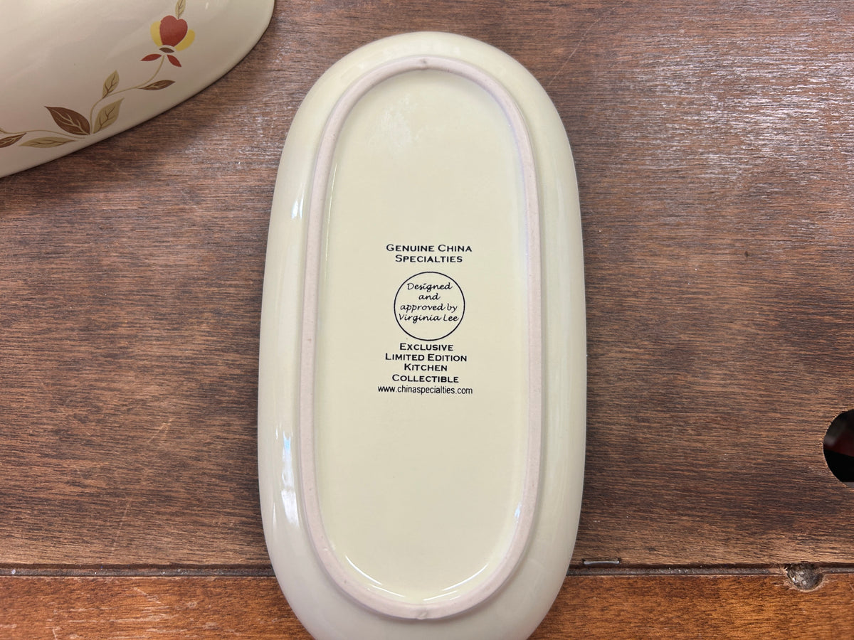 Oval butter dish underside with printed brand text, white ceramic base