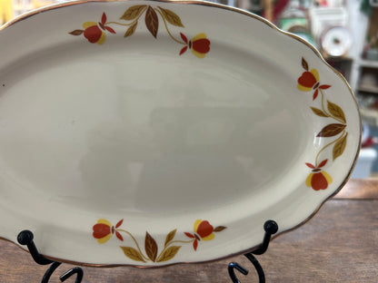Oval white porcelain gravy plate with autumn leaves and berries on outer edge
