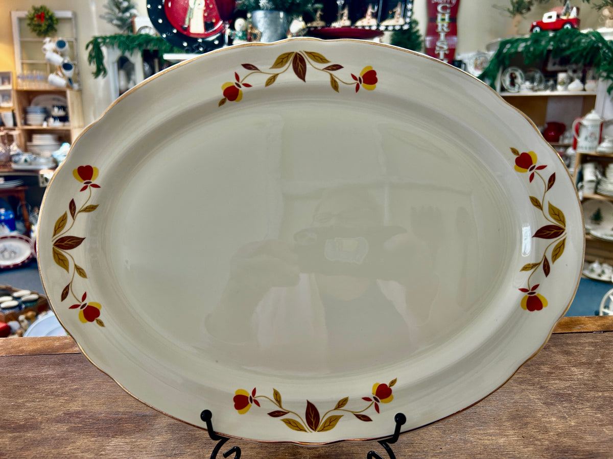 White oval serving platter with multicolor autumn leaf border around the rim