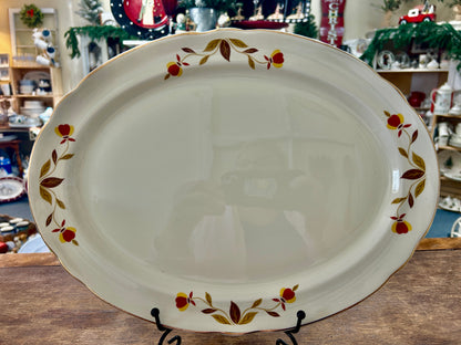 White oval serving platter with multicolor autumn leaf border around the rim