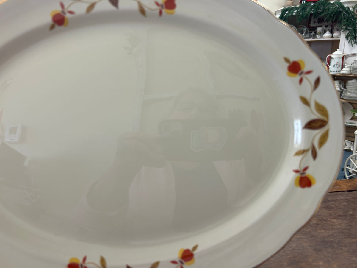 White oval platter with multicolor autumn leaf pattern on the rim edge