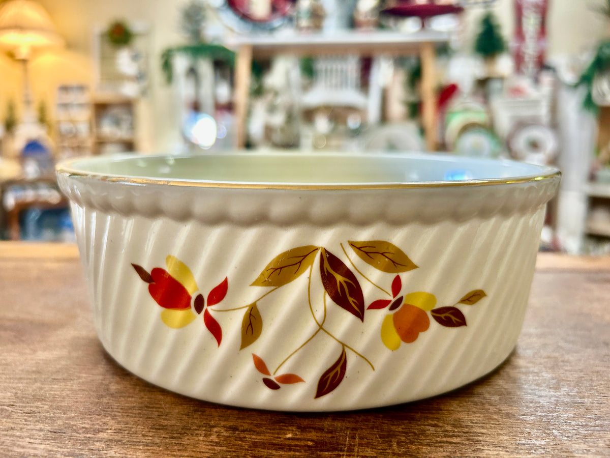 Ceramic souffle bowl with multicolor autumn leaf pattern on cream exterior