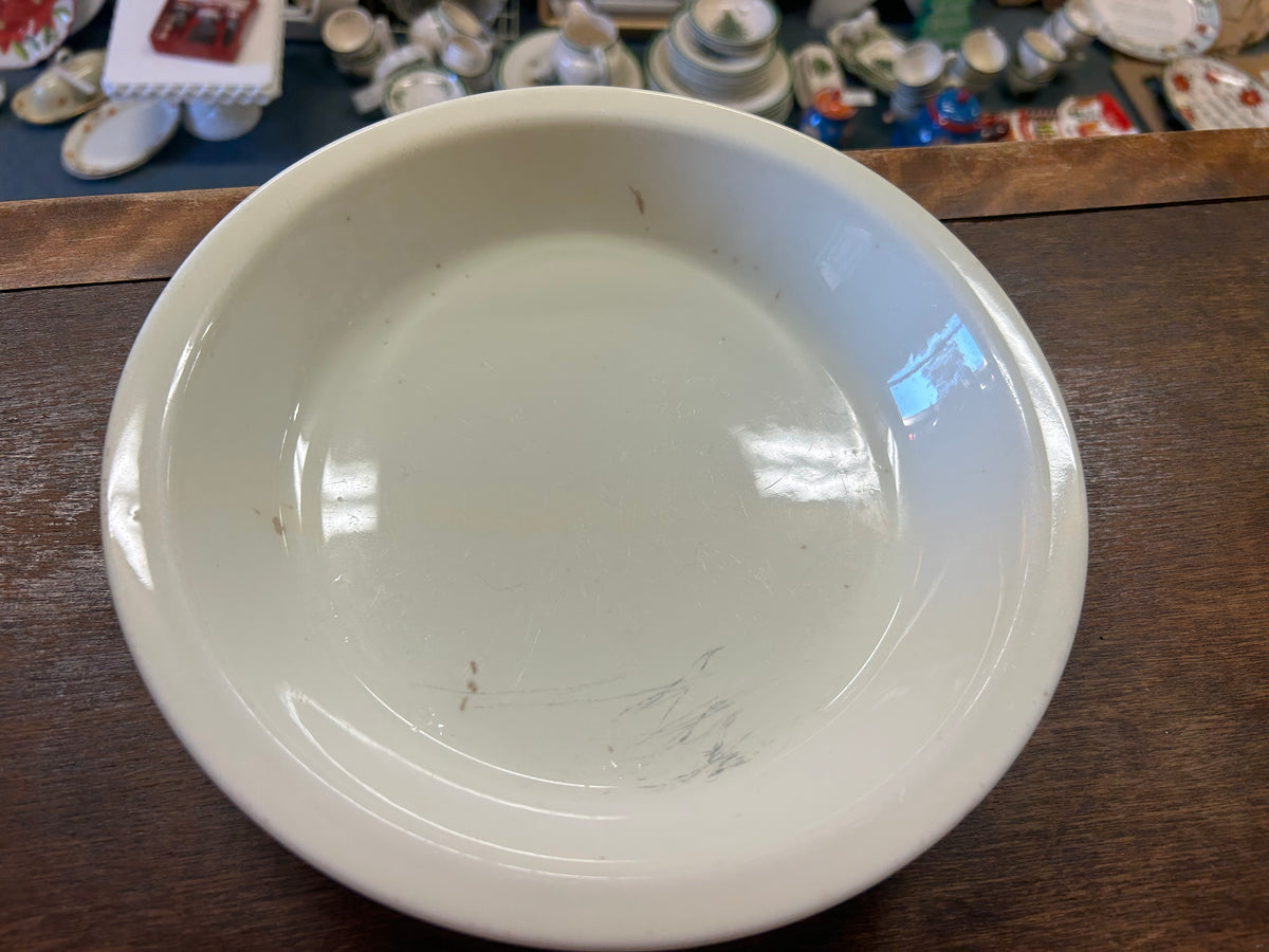 White ceramic pie plate underside, shallow round shape