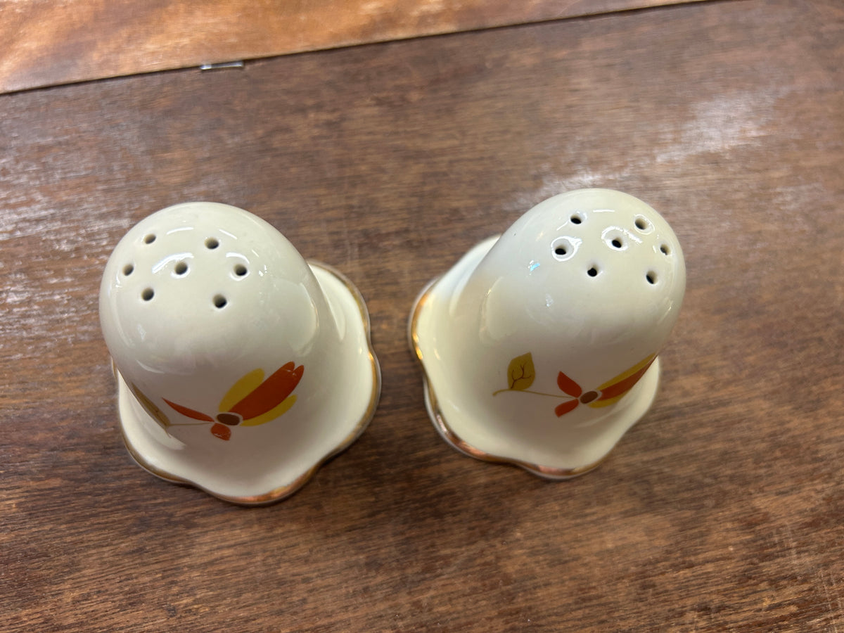 Ceramic salt and pepper shakers, leaf motif and perforated tops, white