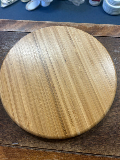 Round wooden serving board with a smooth, unpartitioned back
