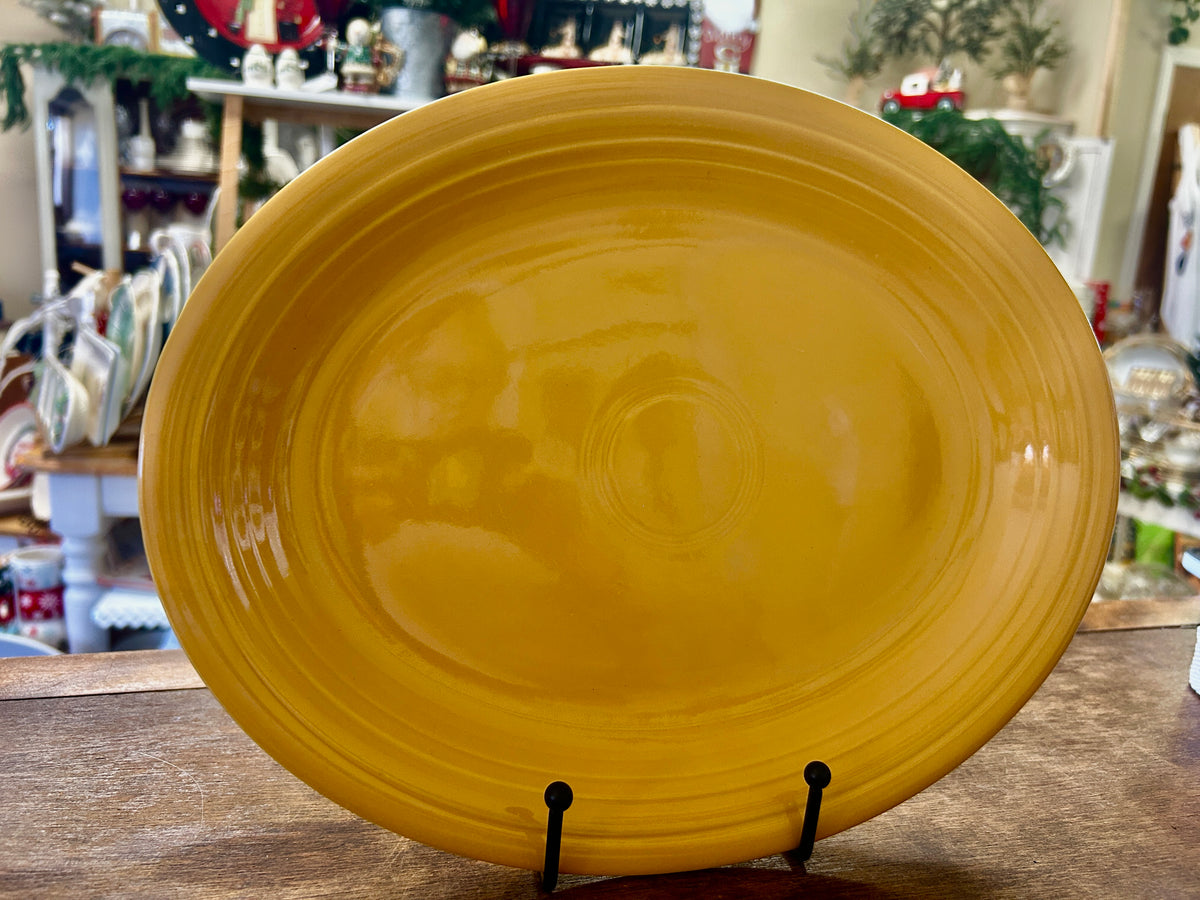 Fiestaware orange oval platter with a glossy finish and raised concentric rim