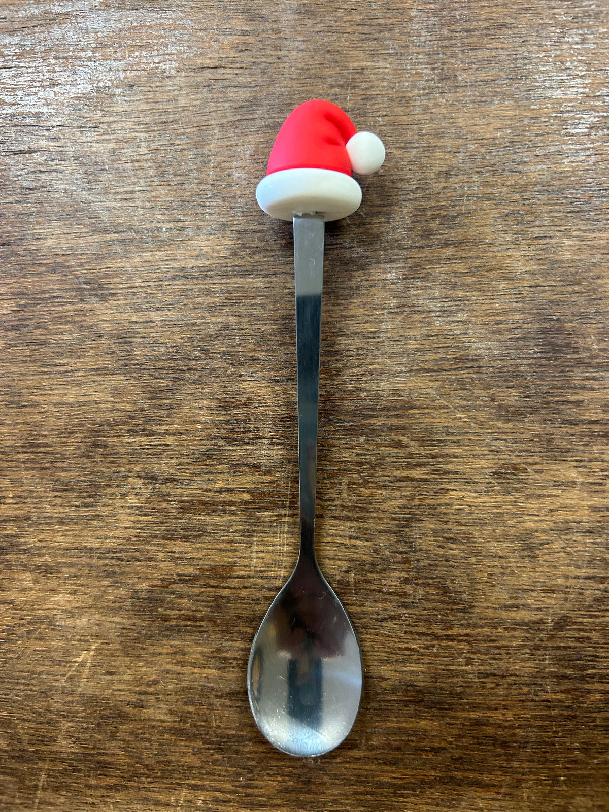 Silver spoon with a red and white Santa hat handle
