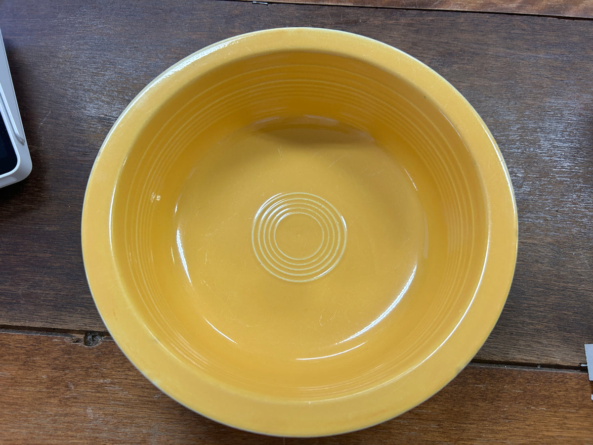 Fiestaware yellow rimmed bowl, 8.5 inches, shown from above with concentric base rings