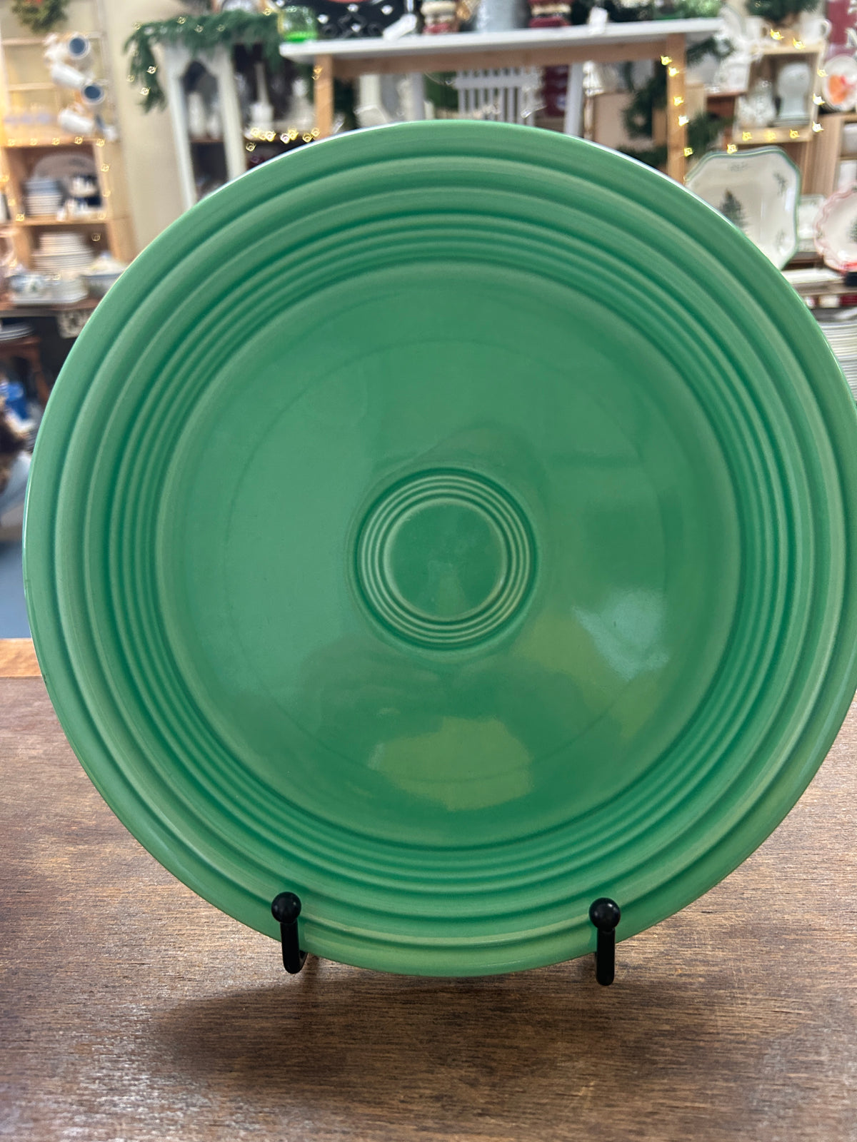 Fiestaware 9.5-inch green plate, front view with concentric raised rings.