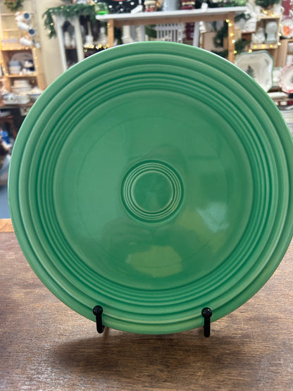 Fiestaware 9.5-inch green plate, front view with concentric raised rings.