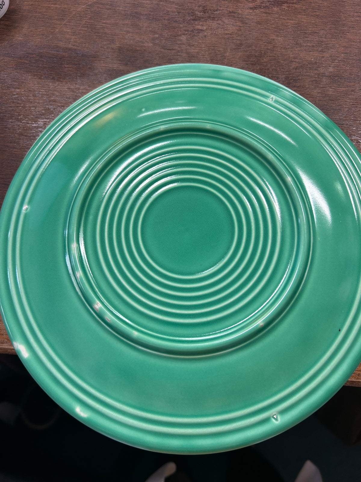 Fiestaware green plate, close-up of the underside and raised ring design.