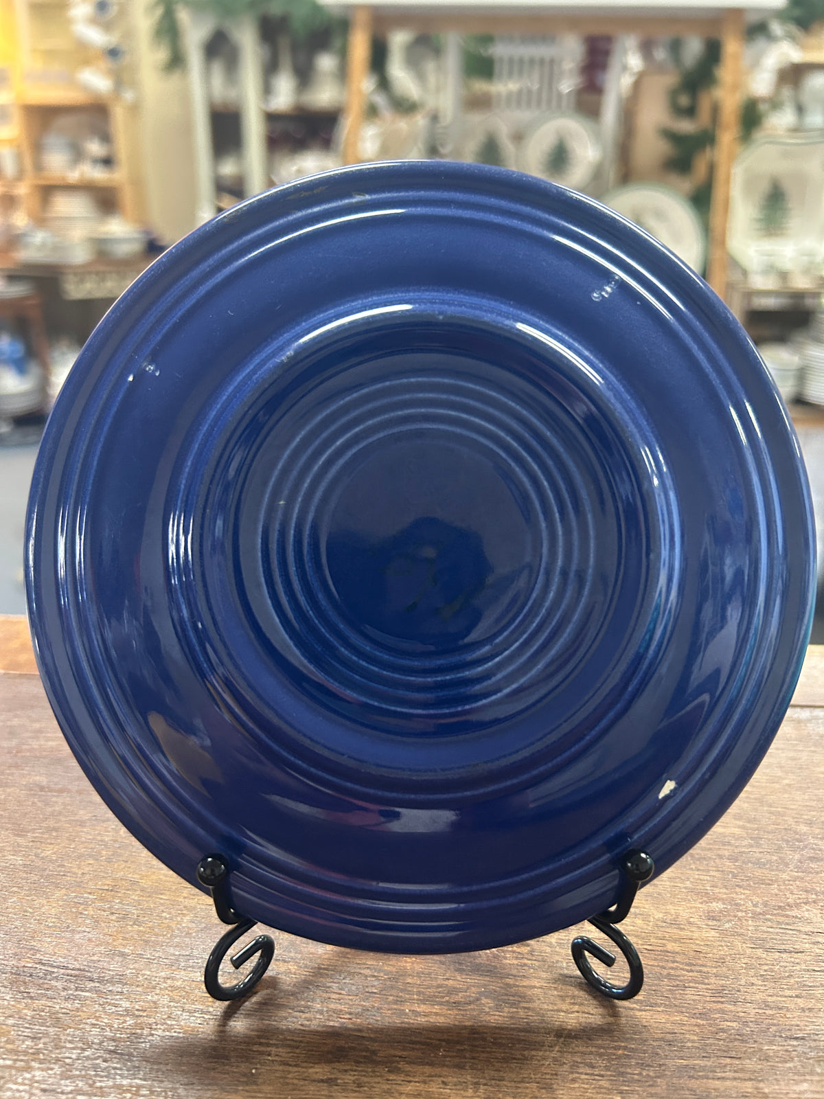 Reverse of cobalt blue Fiestaware plate, showing concentric rings and glossy glaze.