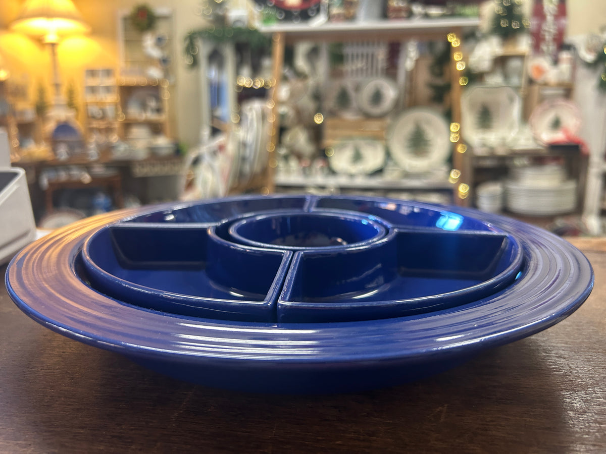 Side view of cobalt blue relish tray with four sections and a raised center bowl