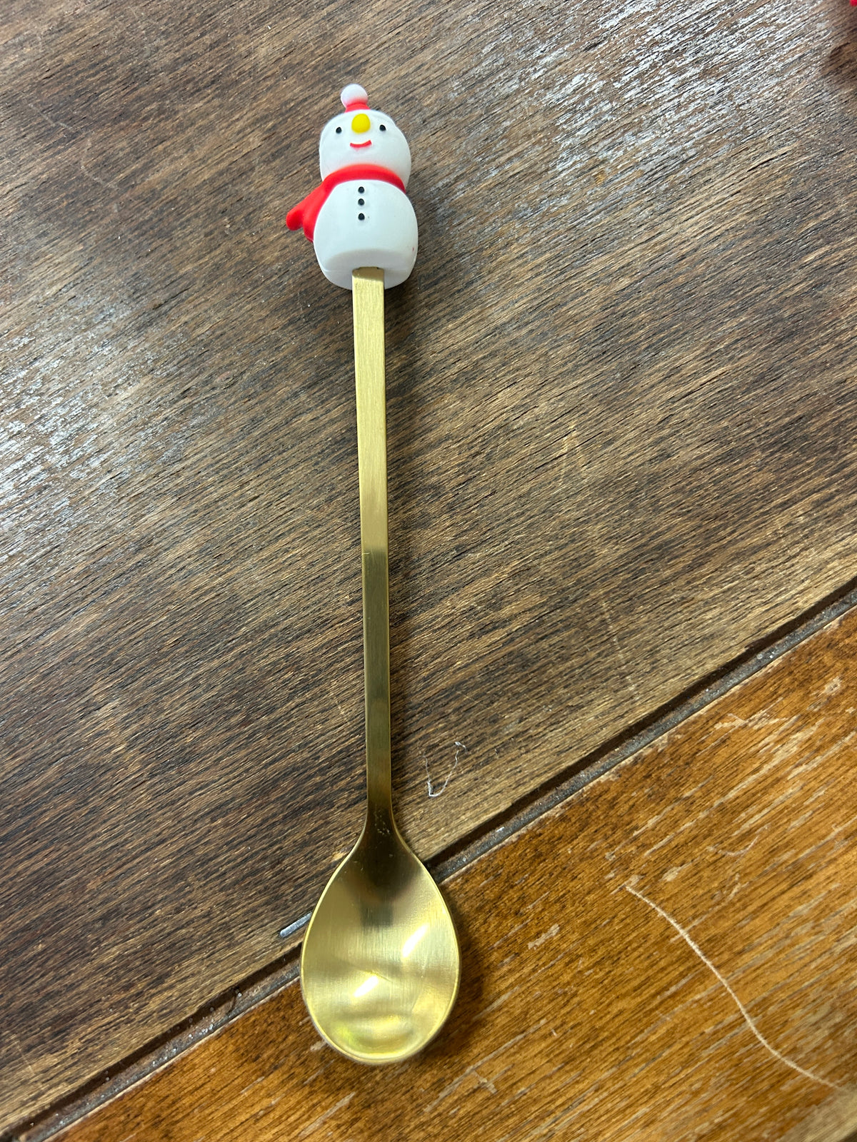 Gold-tone spoon with a white snowman figure on the handle
