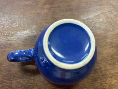 Upside-down blue cup with an unglazed ring around the base