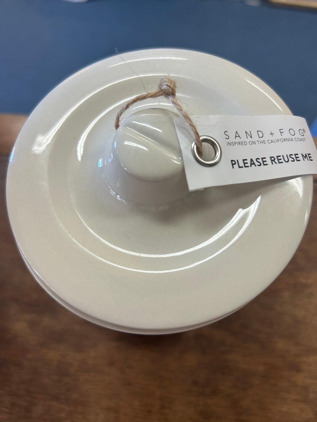 Cream ceramic candle crock lid with twine loop and reuse tag
