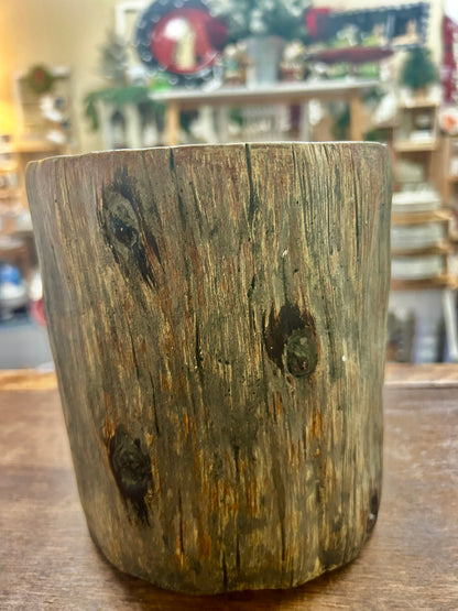 Provencal tree crock showing its weathered, wood-grain exterior and dark knots.