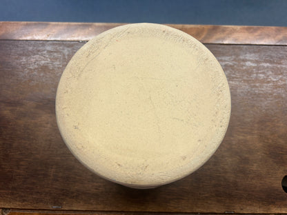 Crock base viewed from below, showing an unglazed, textured cream surface.