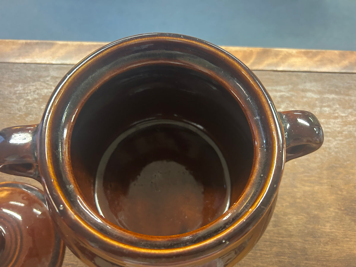 Open bean pot showing its dark glazed interior and two side handles